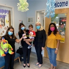 Four dental team members with young dental patient in the Lake Nona Region