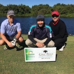 Three dentists next to sign on golf course for Lake Nona Region dental office