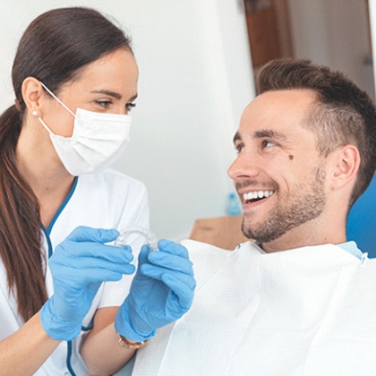 dentist talking to patient about Invisalign