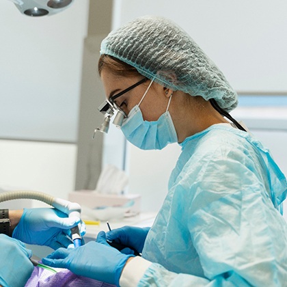 a dentist removing a wisdom tooth