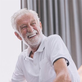 Man laughing on a couch