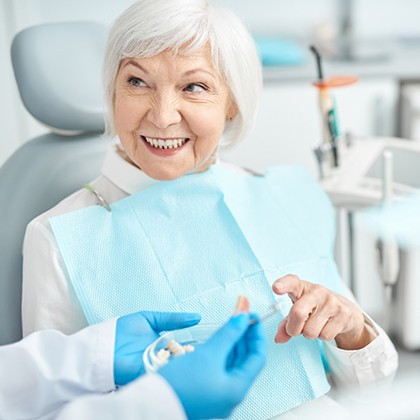 mature woman talking to dentist