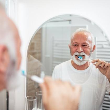  Man brushing teeth to prevent dental emergencies in Lake Nona 