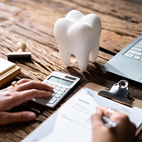 a finance person writing a dental invoice for a patient