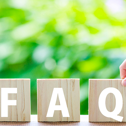 Three wooden blocks with the letters FAQ