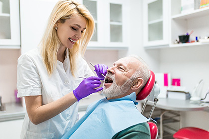 Older couple smiling and enjoying the benefits of dental implants