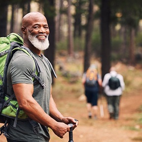 a mature man going on a hike with friends