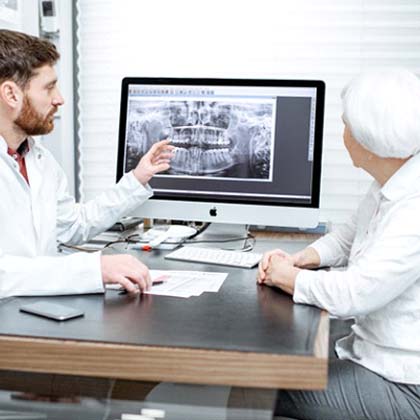 dentist showing patient X-rays