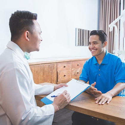 patient talking to dentist about cost of full mouth reconstruction 