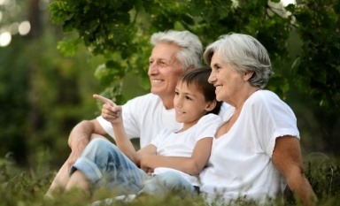 Grandparents and granchild smiling after dental treatment