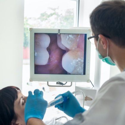 Dentist using intraoral camera to capture images