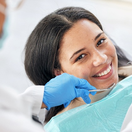 a patient having their mouth examined by a dentist